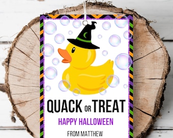 May include: A Halloween-themed gift tag with a yellow rubber duck wearing a witch's hat and surrounded by bubbles. The tag says "Quack or Treat" and "Happy Halloween" with the name "Matthew" at the bottom.