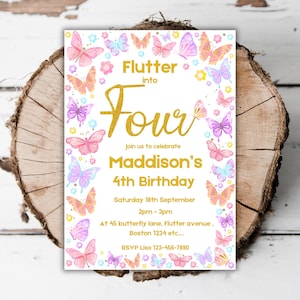 May include: A white invitation card with a gold glitter design. The card features a butterfly theme with pink, purple, and blue butterflies. The text on the card reads "Flutter into Four, Join us to celebrate Maddison's 4th Birthday, Saturday 18th September 2pm - 3pm, At 45 butterfly lane, Flutter avenue, Boston 1234 etc..., RSVP Lisa 123-456-7890".