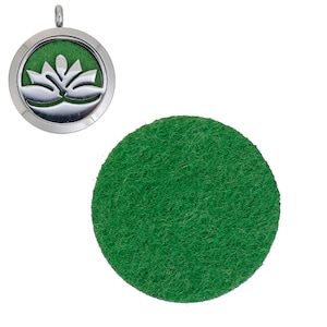 May include: A silver locket with a lotus flower design and a green felt pad. The locket is open and the felt pad is visible.