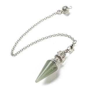 May include: A pendulum with a green gemstone cone and silver-colored chain. The pendulum has a decorative silver-colored cap and a small ball at the chain's end. The chain is attached to a clasp. The background is white.