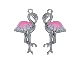 May include: Two silver flamingo charms with pink and white enamel. The charms have a loop at the top for attaching to jewelry.
