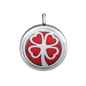May include: Silver pendant with a four-leaf clover design. The clover is cut out and the background is red.