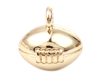 May include: A gold-colored metal charm shaped like a football. The charm has a loop at the top for attaching to a necklace or bracelet.