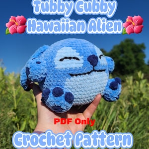 May include: A blue crochet alien plushie with a smiling face, dark blue accents, and a round body. The text "Tubby Cubby Hawaiian Alien" and "Crochet Pattern" are displayed. The image is set against a blue sky background.