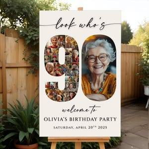 May include: A personalized 90th birthday party welcome sign. The sign features the text "look who's" above the number 90, which is filled with photos. The text "welcome to Olivia's Birthday Party" and the date are below.