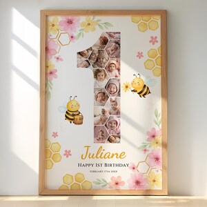 May include: A framed photo collage featuring a baby's photos arranged in the shape of the number one. The design includes watercolor bees, flowers, and honeycomb patterns. The name "Juliane" and birthday details are also displayed.
