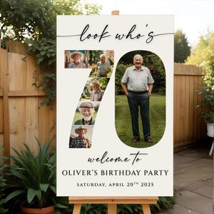 May include: A cream-coloured birthday party sign on an easel. The sign features the words "look who's" in cursive, the number 70 with photos, and the text "welcome to OLIVER'S BIRTHDAY PARTY SATURDAY, APRIL 20TH 2025."