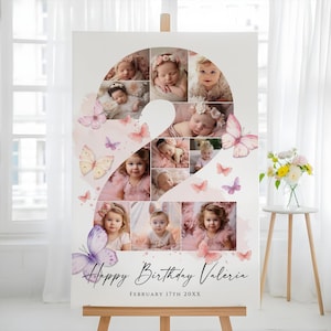May include: A personalised birthday sign with a collage of baby photos in the shape of the number two. The sign includes watercolour butterflies and the text "Happy Birthday Valeria" and the date "February 17th 20XX". The sign is displayed on a wooden easel.