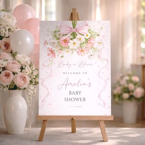 Girl baby shower welcome poster with soft pink flowers and ribbon