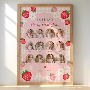 May include: A framed, pink and white gingham print featuring a baby's monthly photos. The print includes the text "SOPHIA'S Berry First Year" and is decorated with strawberry and flower illustrations. The date "12.03.20XX" is also included.