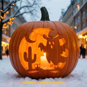 May include: A carved orange pumpkin featuring a cutout design of a ghost and a cactus, illuminated from within by a white candle. The pumpkin has a green stem and is positioned on a snowy surface. The text PUMPKIN CARVING STENCIL is visible.