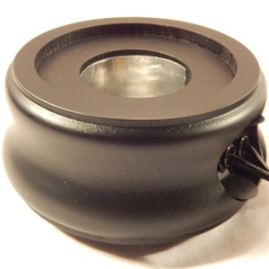 May include: Black wooden base with a round, silver-colored top and a cord coming out of the side.