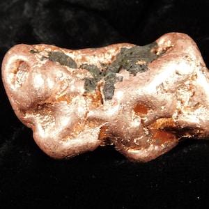 May include: A set of three ceramic mugs with a speckled, matte finish. The mugs are in shades of cream, light brown, and dark brown. Each mug has a simple, minimalist design and a rounded handle.