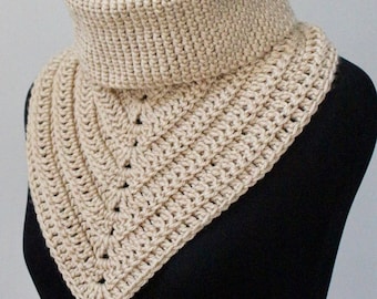 May include: A beige crocheted cowl neck scarf with a triangular shape. The scarf is made with a simple stitch pattern and has a ribbed texture.