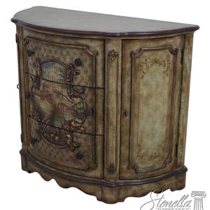 May include: A curved wooden cabinet with a green and brown painted finish. The cabinet has three drawers with a painted scene on each drawer and a single door on the right side. The cabinet has ornate details and a dark brown top.
