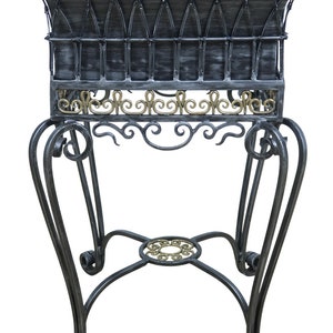 May include: A rectangular metal planter with a dark gray distressed finish, featuring a wire cage design around the top. The stand has four curved legs with gold-toned scrollwork accents and a central circular gold-toned medallion at the base.