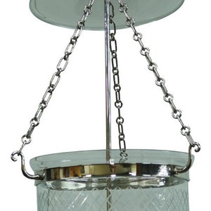 May include: A silver chain-hung pendant light fixture with a clear glass shade featuring a diamond pattern. The shade is attached to a round, silver base.