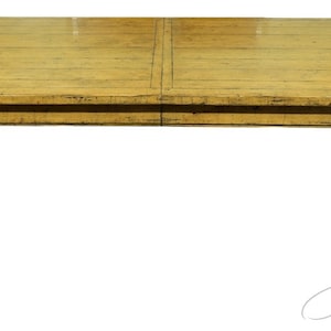 May include: A rectangular, wooden dining table with a distressed, yellow finish. The table has a simple design with four legs and a flat top.