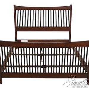 May include: A dark brown wooden bed frame featuring a tall headboard and a lower footboard, both constructed with a series of vertical slats. The frame includes side rails and a central support beam with adjustable metal legs for stability.