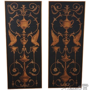 May include: Two rectangular wall panels with a black background and gold-colored ornate designs. Each panel features a central vase, swans, and floral elements. The panels have a gold border and are suitable for interior decor.