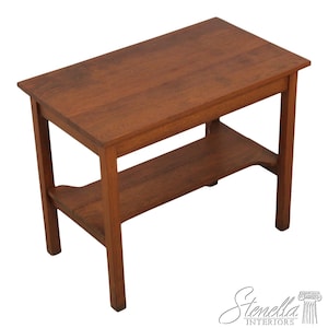 May include: A rectangular wooden side table with a lower shelf. The table is made of a warm brown wood and has a simple, classic design. The table measures approximately 30 inches long, 18 inches wide, and 24 inches high.