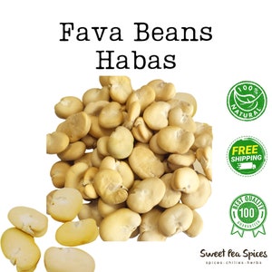 May include: A close-up of a pile of dried fava beans, also known as broad beans or habas. The beans are a pale yellow color and have a slightly wrinkled texture. The image includes the text "Fava Beans Habas" and "100% Natural" with a green leaf logo.