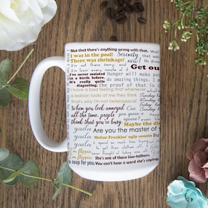 May include: White ceramic coffee mug with a colorful design featuring a variety of text, including "Serenity Now!" and "Get out!" The text is in a variety of fonts and colors, including red, yellow, and black.