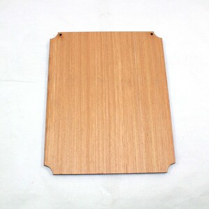 May include: A plain, light brown wooden sign with rounded corners and two small holes at the top for hanging.