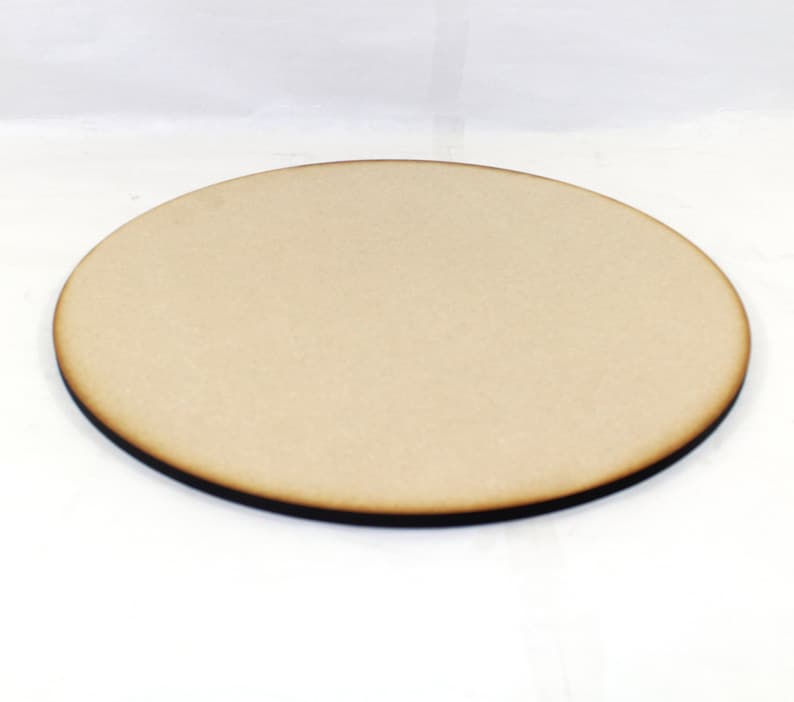 May include: A round, unfinished wooden disc with a dark brown edge. The disc is approximately 10 inches in diameter.