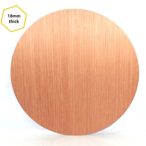 May include: A round piece of wood, 18mm thick, with a natural wood grain finish.