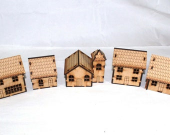 May include: Six miniature wooden houses with brown roofs and windows. The houses are made of laser-cut plywood and are unpainted.