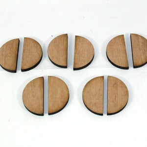 May include: Six wooden half-circles, each with a dark brown edge, are arranged in two rows of three. The half-circles are all the same size and shape.