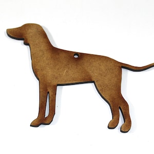 May include: A brown wooden cutout of a dog, possibly a hound, in a standing position. The cutout has a hole at the top for hanging.