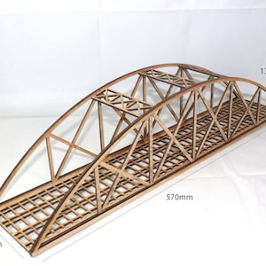May include: A wooden model bridge kit with a lattice design. The bridge is 570mm long and 130mm high. The bridge is 110mm wide.