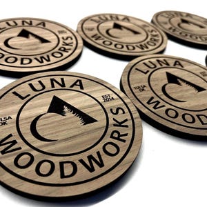 Premium engraved wood coasters made to order with your logo or message. Perfect for corporate gifts, weddings, or sustainable branded packaging.
