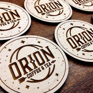 Set of personalized wooden coasters for weddings, businesses, or home décor. Laser-engraved with logos, names, or special dates for a meaningful and practical gift.