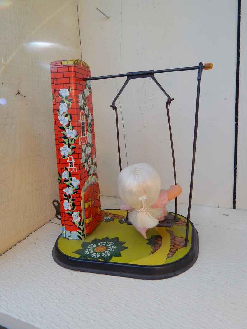 Vintage Wind Up Tin Lithograph Toy Girl On Swing With Key Retro Wind Up Toy With Moving Swing Blonde Doll And Primary Colors On Tin