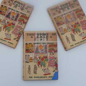 May include: Three vintage children's books with colorful illustrations on the covers. The books are titled "The Story of a Calico Clown", "The Story of a Nodding Donkey", and "The Story of a China Cat". All three books are part of a series called "The Make-Believe Stories".