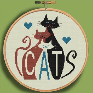 May include: Cross-stitch embroidery hoop with a design of three cats, two with hearts above them, and the word "CATS" spelled out with the cats' bodies. The cats are black, brown, and white.