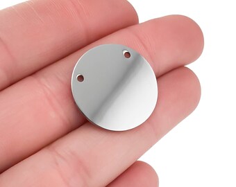 May include: A silver round metal charm with two holes for attaching to jewellery or other crafts.