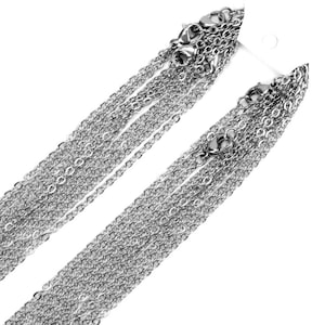 May include: A set of silver chains, all of the same style, but different lengths. The chains are displayed on a white background.