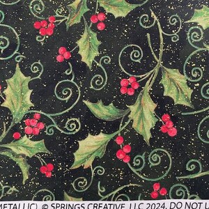 May include: A black fabric featuring a pattern of green holly leaves, red berries, and gold metallic swirls. The white selvage edge displays the text METALLIC, &copy; SPRINGS CREATIVE, LLC 2024. DO NOT U, positioned above a ruler showing inches.