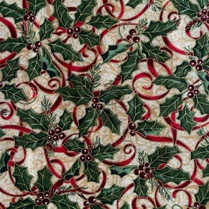 May include: A fabric pattern featuring dark green holly leaves and clusters of small red berries intertwined with swirling red ribbons on a cream-coloured background with a subtle, light gold swirling texture throughout the design.