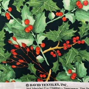 May include: Fabric featuring a pattern of green holly leaves and bright red berries on a black background. The white selvage edge includes the text DAVID TEXTILES, INC. and Not Intended For Children's Sleepwear, positioned above a ruler showing inches.