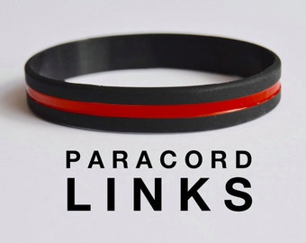 May include: Black paracord bracelet with a single red stripe. The bracelet has the text "PARACORD LINKS" printed below it.
