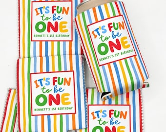 May include: A collection of foam can coolers featuring a vertical rainbow stripe pattern. Each cooler displays a white rectangular label with the colorful text IT'S FUN to be ONE and the personalized name Bennett's 1st Birthday printed below.