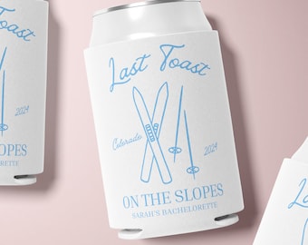 May include: White can cooler with blue text and graphic. The text reads "Last Toast Colorado 2024 On The Slopes Sarah's Bachelorette". The graphic is a pair of crossed skis with ski poles.