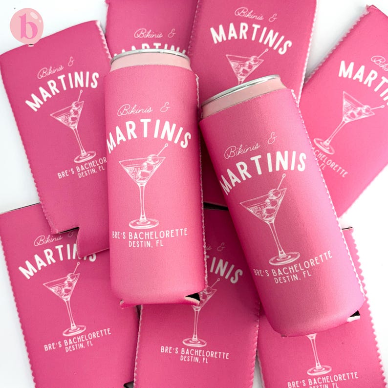 May include: Pink can coolers with the text "Bikinis & Martinis" and a martini glass graphic. The text "Bre's Bachelorette Destin, FL" is also printed on the coolers.