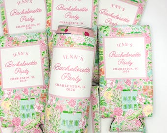 May include: A collection of pink and floral-patterned can coolers and a can. The text "JENN'S Bachelorette Party CHARLESTON, SC 2026" is printed on the coolers and the can. The design includes a house illustration.