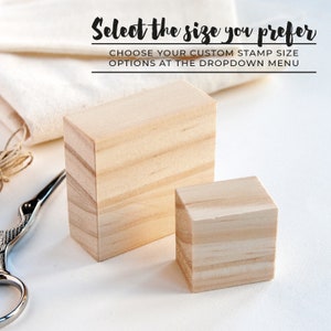 May include: Two wooden blocks, one larger than the other, on a white surface. The text "Select the size you prefer" is above the blocks. The text "CHOOSE YOUR CUSTOM STAMP SIZE OPTIONS AT THE DROPDOWN MENU" is below the blocks.